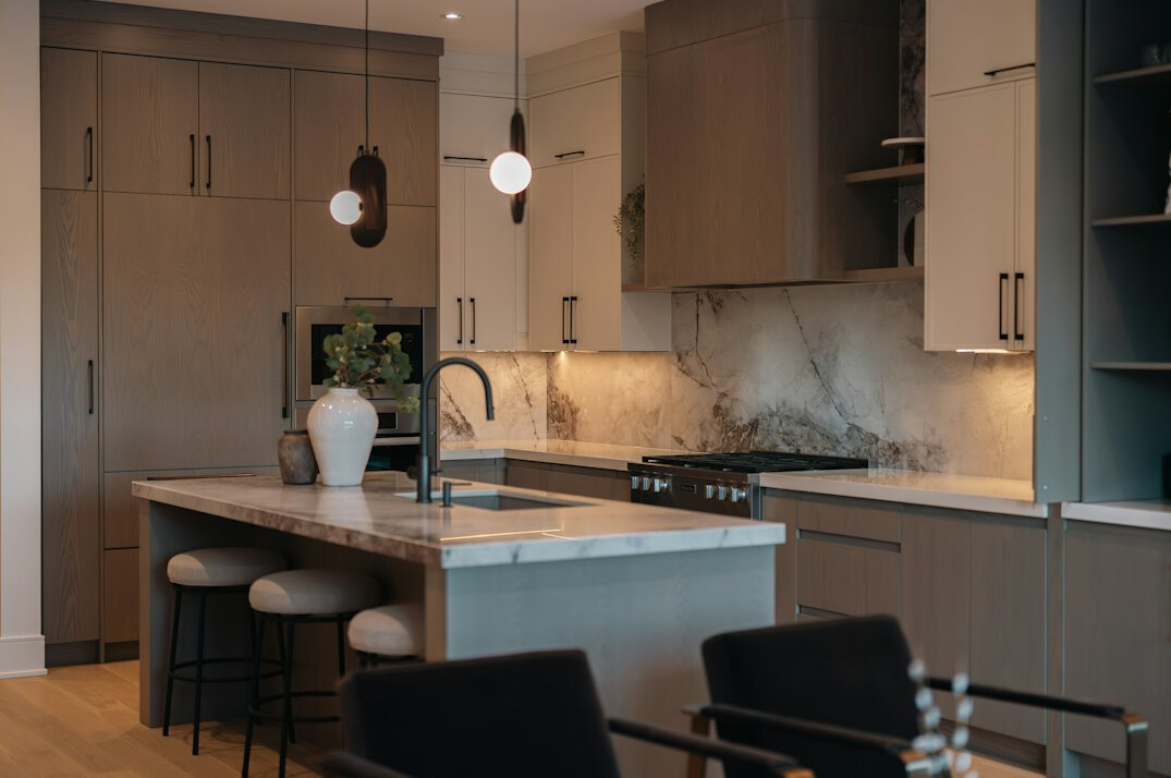 Modern kitchen with marble island and pendant lights