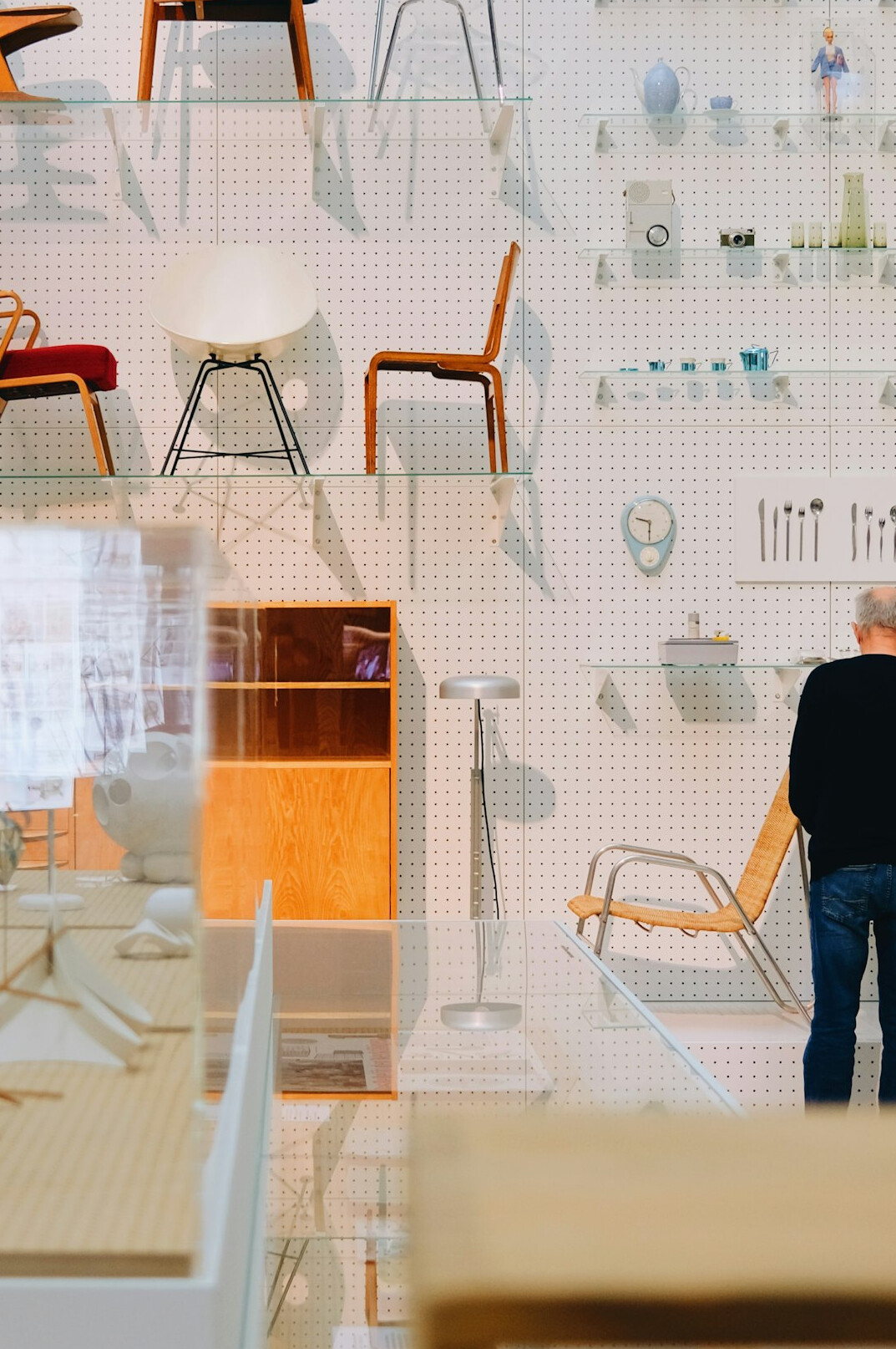 Two professionals shaking hands over a desk with design samples